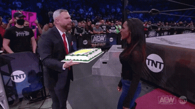 Man In Suit Holding Cake In Wrestling Ring TNT GIF