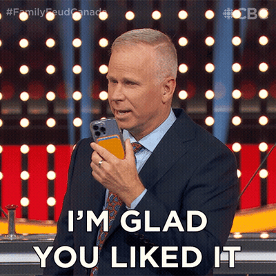 Man In Suit Holding Cell Phone Says I'm Glad You Liked It GIF