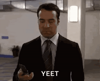 Man In Suit Holding Cell Phone Says Yeet GIF