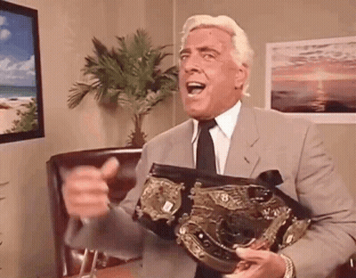 Man In Suit Holding Championship Belt GIF