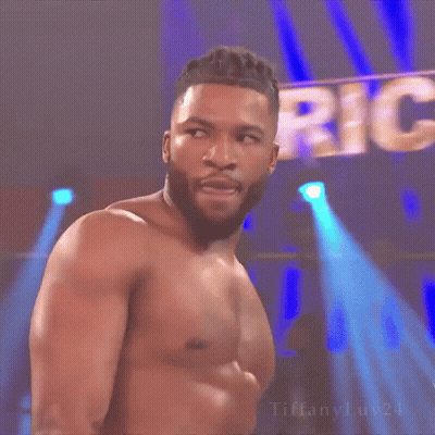 Man In Suit Holding Championship Belt With Another Man Behind GIF