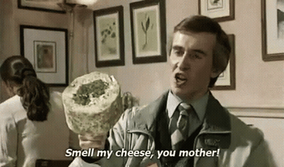Man In Suit Holding Cheese Says Smell My Cheese You Mother GIF