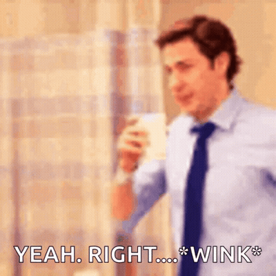 Man In Suit Holding Coffee Saying Yeah Right Wink GIF