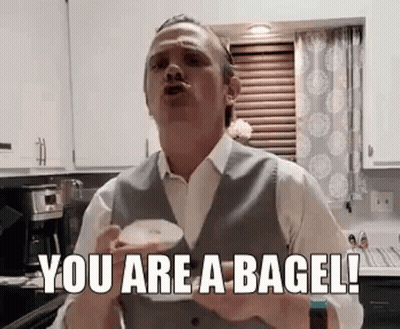 Man In Suit Holding Coffee Saying You Are A Bagel GIF