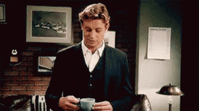 Man In Suit Holding Coffee GIF