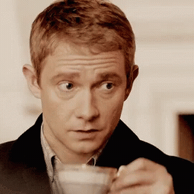 Man In Suit Holding Coffee With Spoon GIF