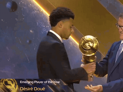 Man In Suit Holding Emerging Player Of The Year Trophy GIF