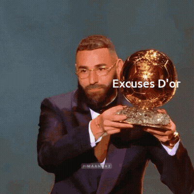 Man In Suit Holding Excuses D'Or Trophy GIF