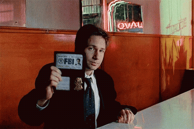Man In Suit Holding FBI Badge GIF