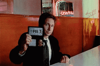 Man in Suit Holding FBI Badge