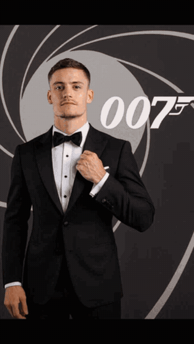 Man In Suit Holding Fireball In Front Of 007 Poster GIF