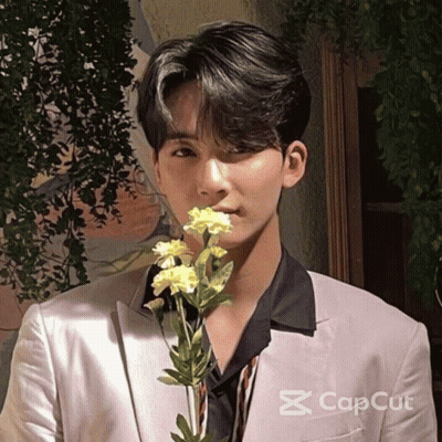 Man In Suit Holding Flower In Mouth Cap Cut GIF