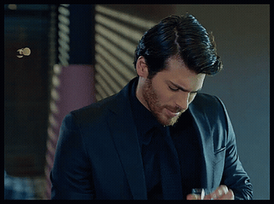 Man In Suit Holding Glass GIF