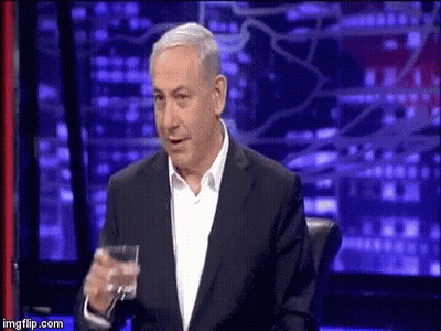 Man In Suit Holding Glass Of Water GIF