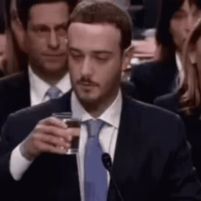 Man In Suit Holding Glass Of Wine GIF