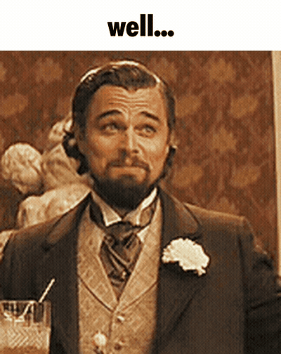 Man In Suit Holding Glass With Straw Saying Well GIF