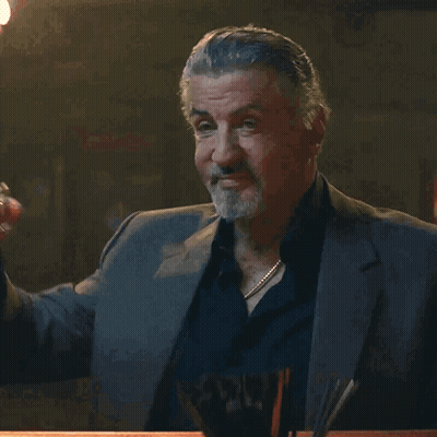 Man In Suit Holding Glass GIF