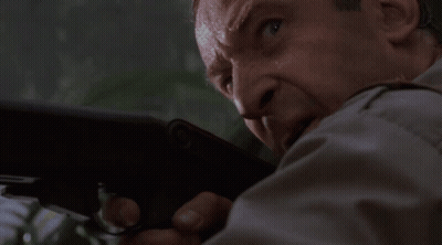 Man In Suit Holding Gun GIF