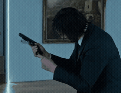 Man In Suit Holding Gun GIF