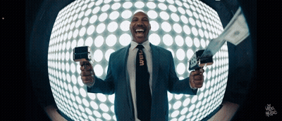 Man In Suit Holding Gun And Stack Of Money GIF