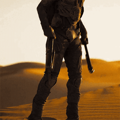 Man In Suit Holding Gun In Desert GIF