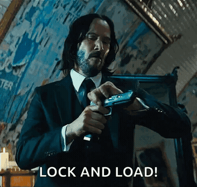 Man In Suit Holding Gun GIF
