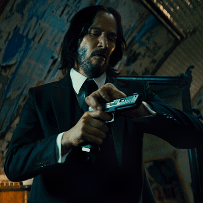 Man In Suit Holding Gun GIF