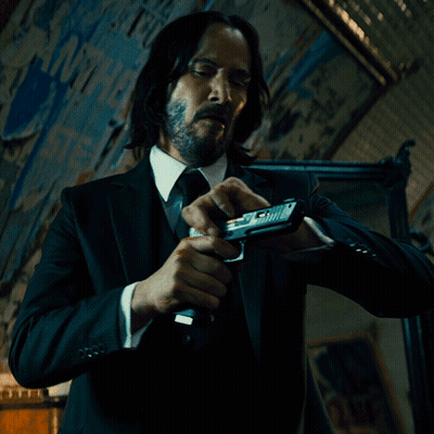 Man In Suit Holding Gun GIF