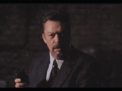 Man In Suit Holding Gun Saying Heavy Breath Again GIF