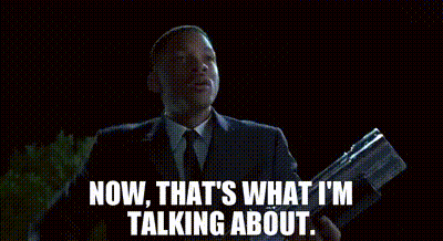 Man In Suit Holding Gun Saying Now That's What I'm Talking About GIF