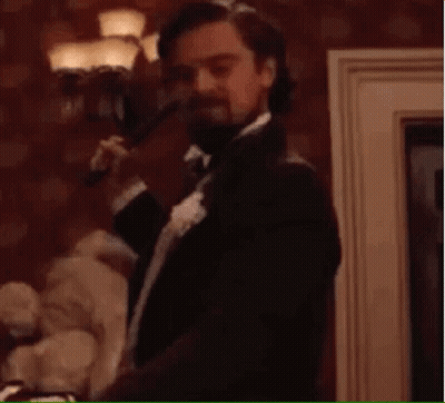 Man In Suit Holding Gun Saying Sold GIF