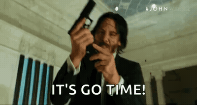 Man In Suit Holding Gun Says Its Go Time GIF