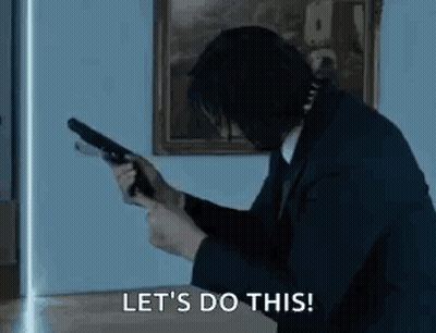 Man In Suit Holding Gun Says Lets Do This GIF