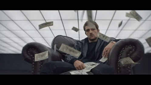 Man In Suit Holding Gun With Dollar Bill GIF