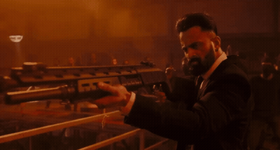 Man In Suit Holding Gun With Letter R GIF