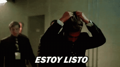 Man In Suit Holding Hair While Another Stands Behind GIF