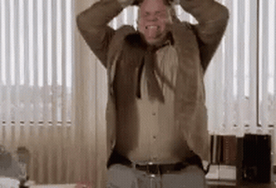 Man In Suit Holding Hands To Head By Window GIF