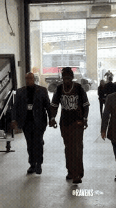 Man In Suit Holding Hands With Security Guard GIF