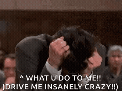 Man In Suit Holding Head Crowd Watches GIF