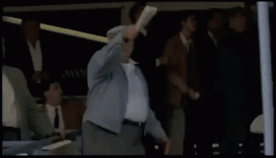 Man In Suit Holding Head In Front Of Crowd GIF