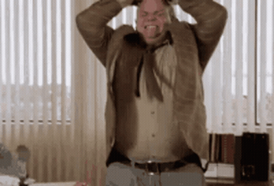 Man In Suit Holding Head GIF