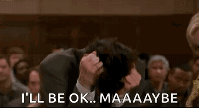 Man In Suit Holding Head GIF