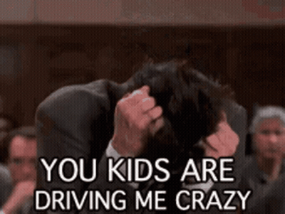 Man In Suit Holding Head Saying You Kids Are Driving Me Crazy GIF
