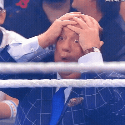 Man In Suit Holding Head Watching Wrestling GIF