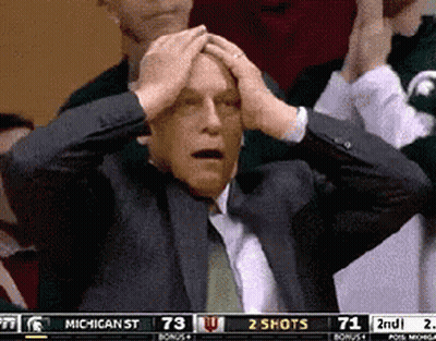 Man In Suit Holding Head While Watching Game GIF