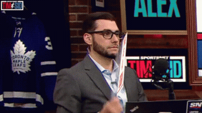 Man In Suit Holding Hockey Stick Sportsnet Sign GIF