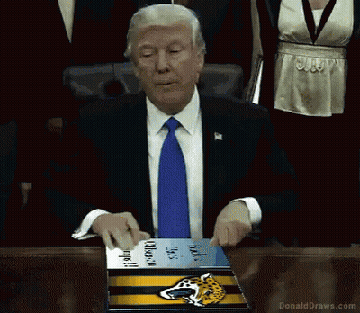 Man In Suit Holding Jaguars Book GIF