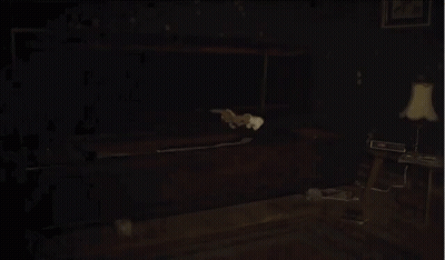 Man In Suit Holding Knife In Dark Room GIF