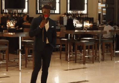 Man In Suit Holding Lollipop GIF