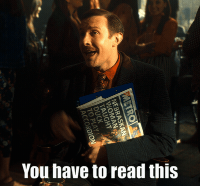Man In Suit Holding Metro Newspaper GIF